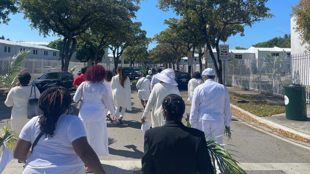 Members of the Historic Saint Agnes Episcopal Church march through the streets of Overtown during their annual Palm Sunday Procession in Miami, Florida on Sunday, April 10, 2022. Known for its primarily Bahamian congregation, the church has been a staple in Black Miami since its founding in 1898.