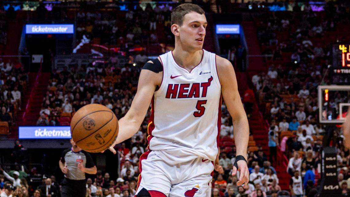 Miami Heat forward Nikola Jovic (5) dribbles the ball during the second half of an NBA game at Kaseya Center in Miami on April 12, 2024.