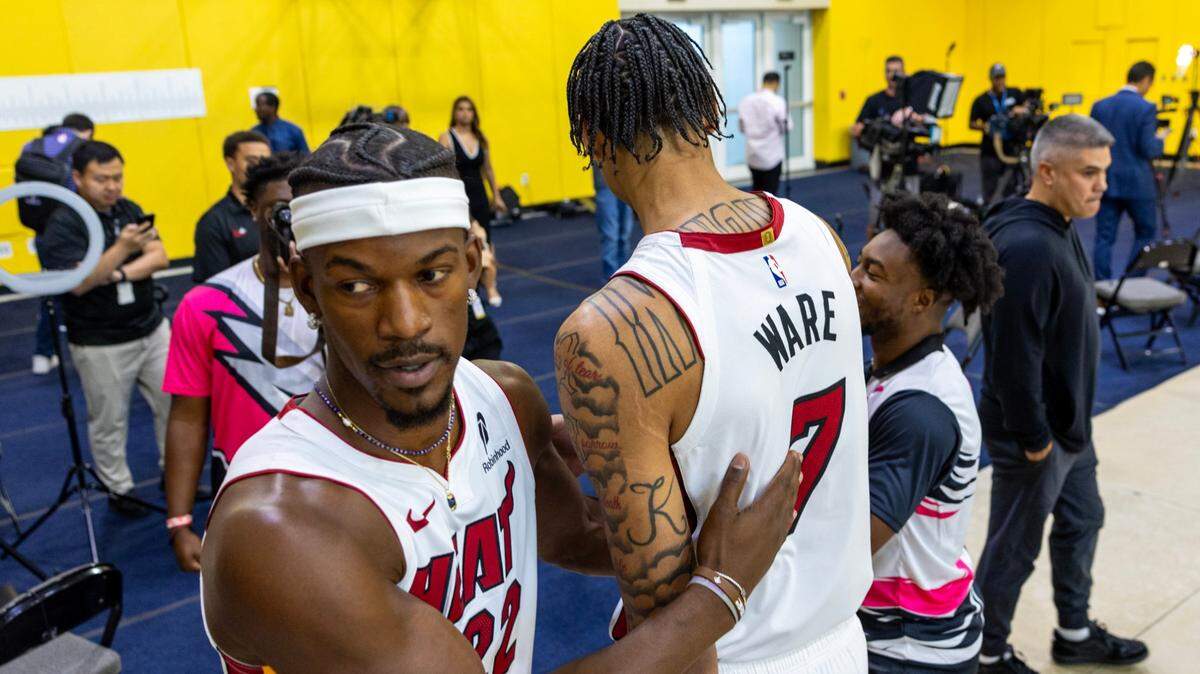 Miami Heat forward Jimmy Butler (22) interacts with rookie center Kel’el Ware (7) during media day at Kaseya on September 30, 2024, in Miami.
