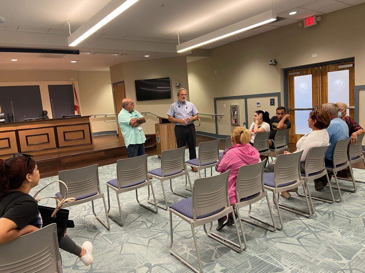 Marathon Building Official Noe Martinez and City Manager George Garrett speak to residents of Mariner Place apartments in a conference room inside Marathon City Hall Thursday, Feb. 24, 2022.