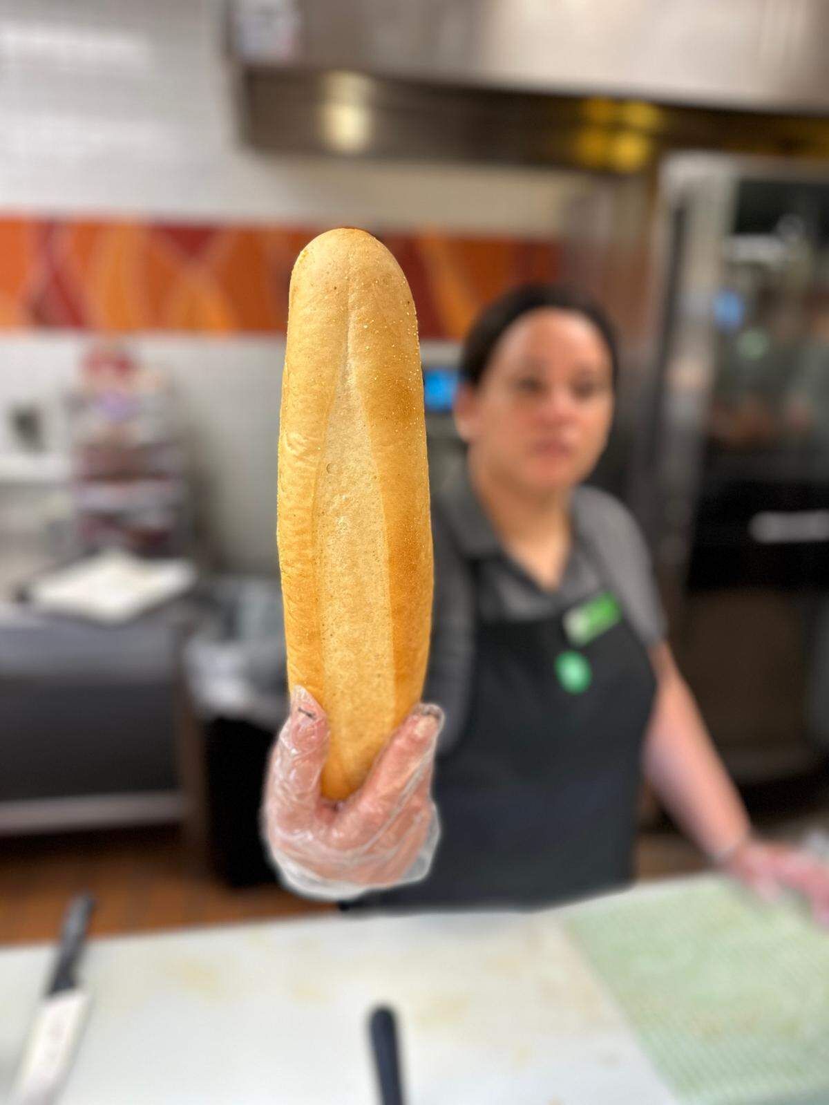 A Publix deli staffer at the Palms at Town & Country supermarket gets ready to make a Pub Sub for a customer on Feb. 14, 2025.