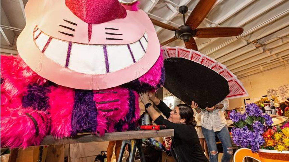 In this photo provided by the Florida Keys News Bureau, Julie Roubik assembles a giant Cheshire cat character Thursday, Oct. 20, 2022, in Key West, Fla. The element is to be incorporated on a float that Roubik and her colleagues are fabricating for the 2022 Fantasy Fest Parade set for Saturday, Oct. 29. Key West’s 10-day Fantasy Fest masking and costuming festival gets underway Friday, Oct. 21, with a full slate of events, the first full festival since the COVID-19 pandemic began in 2020. (Carol Tedesco/Florida Keys News Bureau via AP) CAROL TEDESCO AP