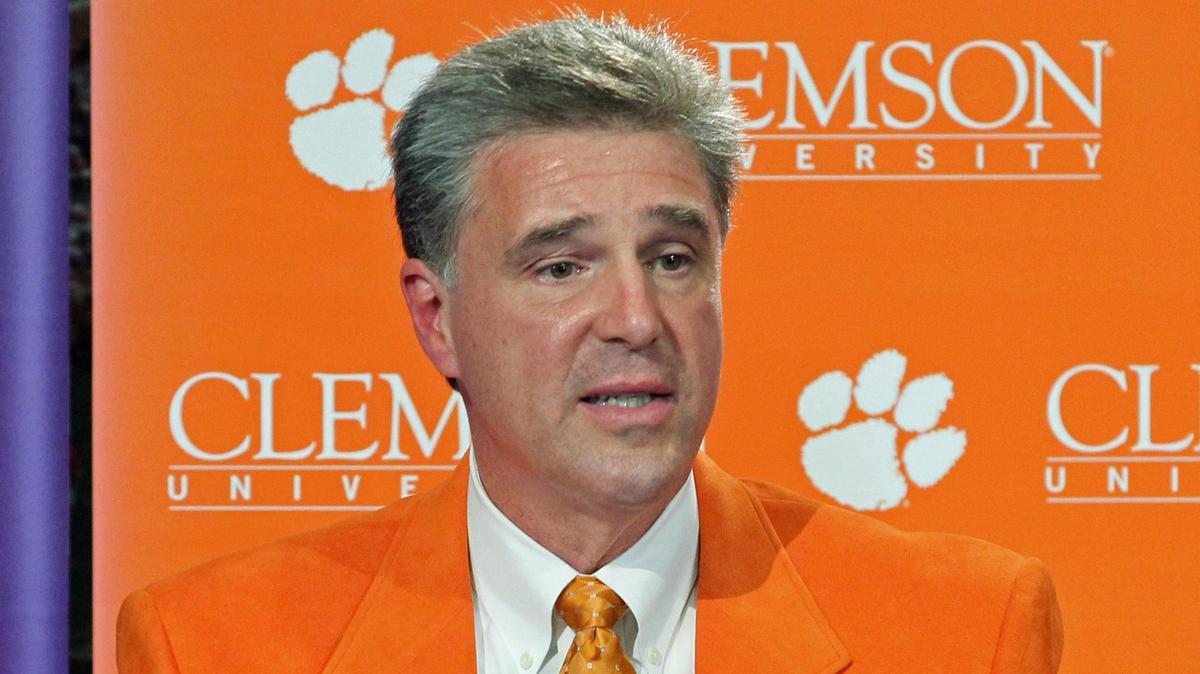 FILE - In this Oct. 29, 2012, file photo, Dan Radakovich answers a question after being introduced as Clemson’s new athletic director in Clemson, S.C. Second-ranked Clemson is the only major conference school in the Carolinas and Virginia largely that will play its scheduled football game this weekend as Hurricane Florence looms. Clemson officials say they are monitoring the storm’s path and believe there were be no issues playing the Saturday’s game against Georgia Southern. Clemson has moved up the start time to noon EST from the original 3:30 p.m. kickoff. (Mark Crammer/The Independent-Mail via AP)