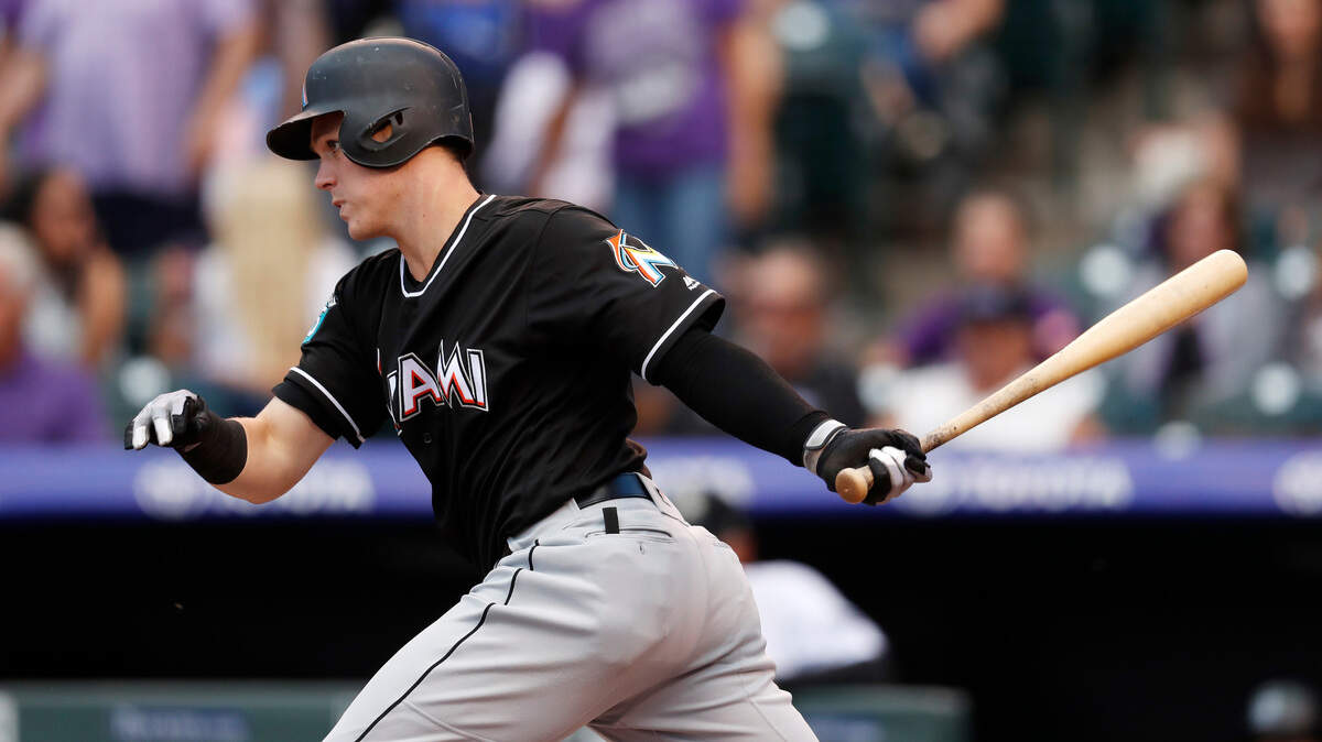 Miami Marlins' Brian Anderson follows the flight of his single off Colorado Rockies starting pitcher Jon Gray in the first inning of a baseball game Friday, June 22, 2018, in Denver. (AP Photo/David Zalubowski)