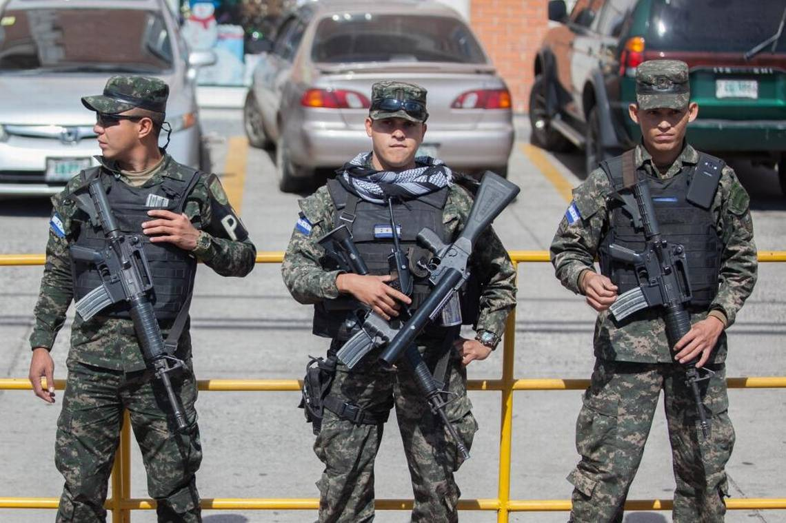Honduran military police officers stand at the edge of a huge protest headed for the U.S. Embassy in Tegucigalpa, Honduras, in Dec. 2017 to challenge the results of a recent presidential election. The paramilitary officers can been seen carrying M4s across their chests, despite not being authorized recipients of U.S. weapons.