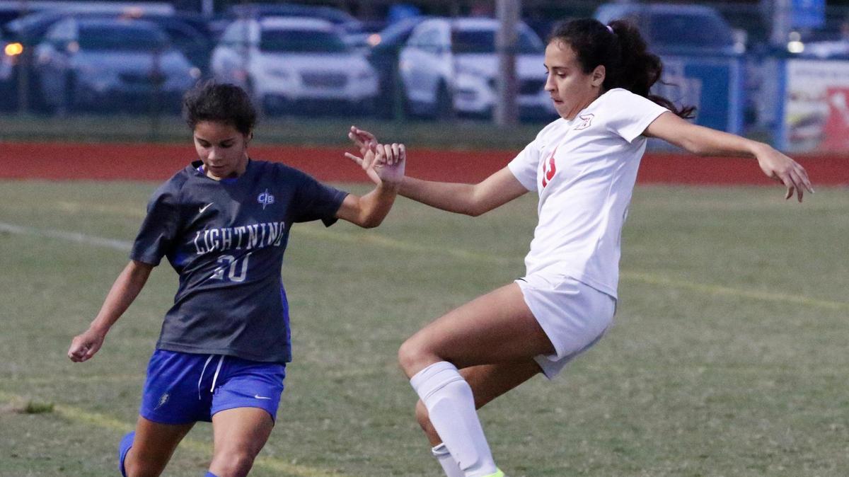 Cypress Bay Lightning Daniela Duran (20) hits the ball during Region 4-7A girls’ soccer semifinal against Doral Firebirds on Friday, February 16, 2024 at Cypress Bay HS in Weston.