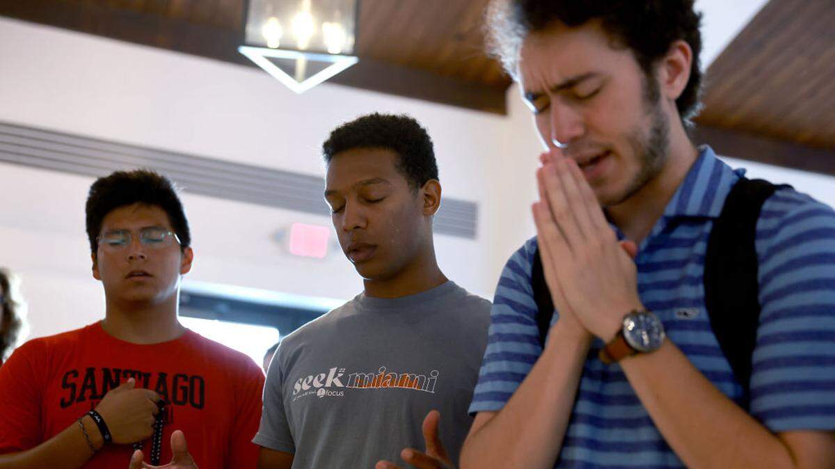 (From left) Kyle Romero, Gabriel Suero Diaz and Joseph Lopez participate in a National Day of Prayer service at the St. Augustine Church on May 5, 2022, in Coral Gables, Florida.