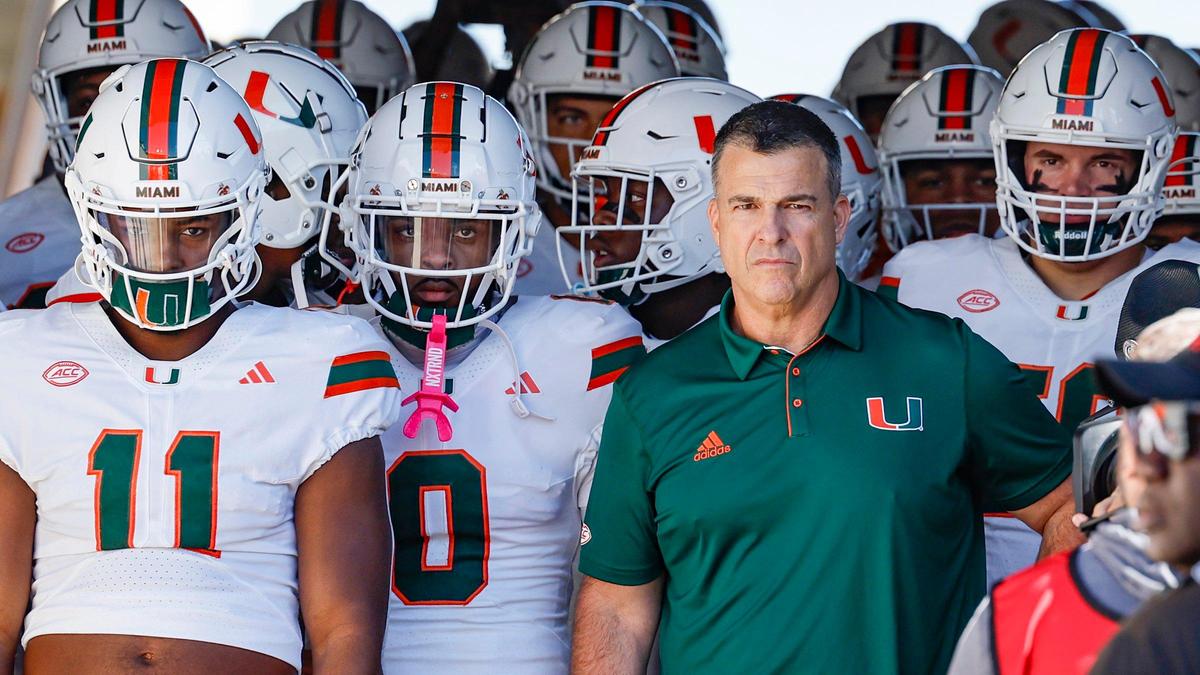 Miami Hurricanes head coach Mario Cristobal joins the team as they prepare to rush the field for the game against the Louisville Cardinals for an NCAA football game at L&N Federal Credit Union Stadium in Louisville, Kentucky on Saturday, October 19, 2024.