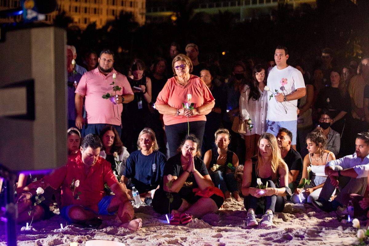 A few hundred people gathered for a community vigil for those missing and deceased after the partial collapse of Champlain Towers South condominium building. They gathered behind the Four Seasons Hotel at The Surf Club in Surfside, near Miami Beach, Florida, on Monday, June 28, 2021.
