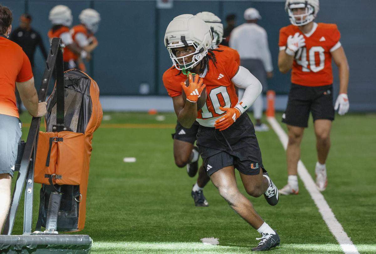 Miami Hurricanes wide receiver Malachi Toney (10) runs through practice drills with teammates at the Carol Soffer Indoor Practice Facility in Coral Gables, Florida, on Thursday, July 31, 2025.