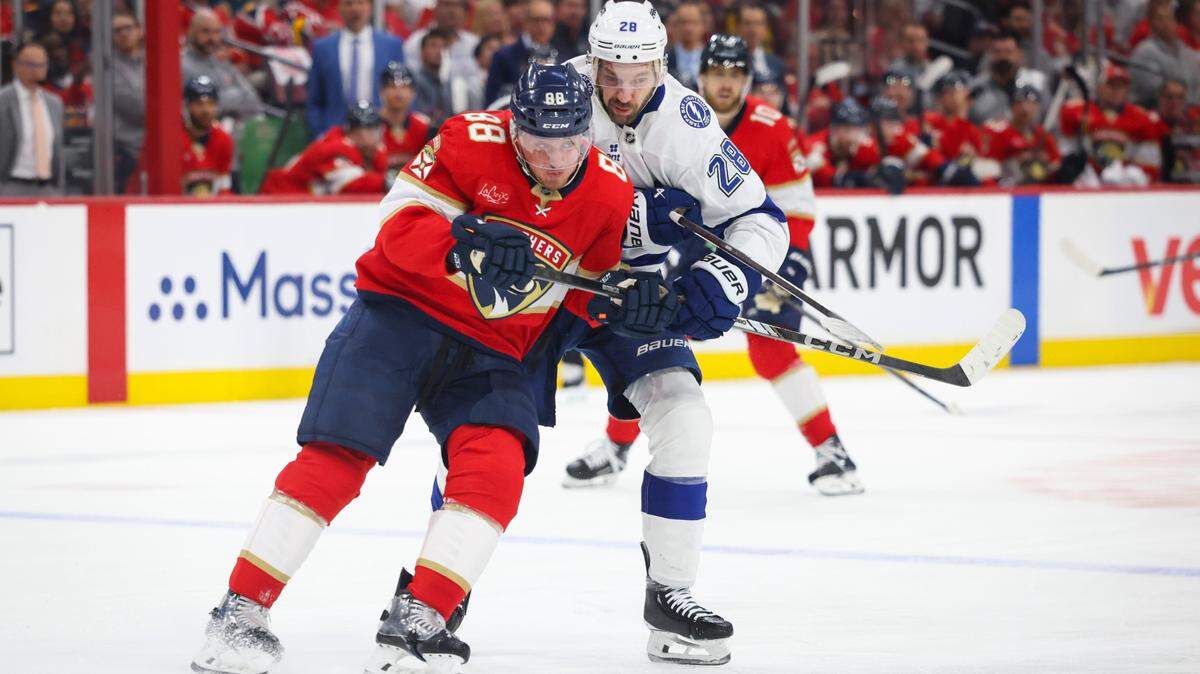 Florida Panthers defenseman Nate Schmidt (88) tries to keep the puck from Tampa Bay Lightning center Zemgus Girgensons (28) during the second period of Game 4 of the first-round Stanley Cup playoff series on Monday, April 28, 2025, at Amerant Bank Arena in Sunrise, Fla.