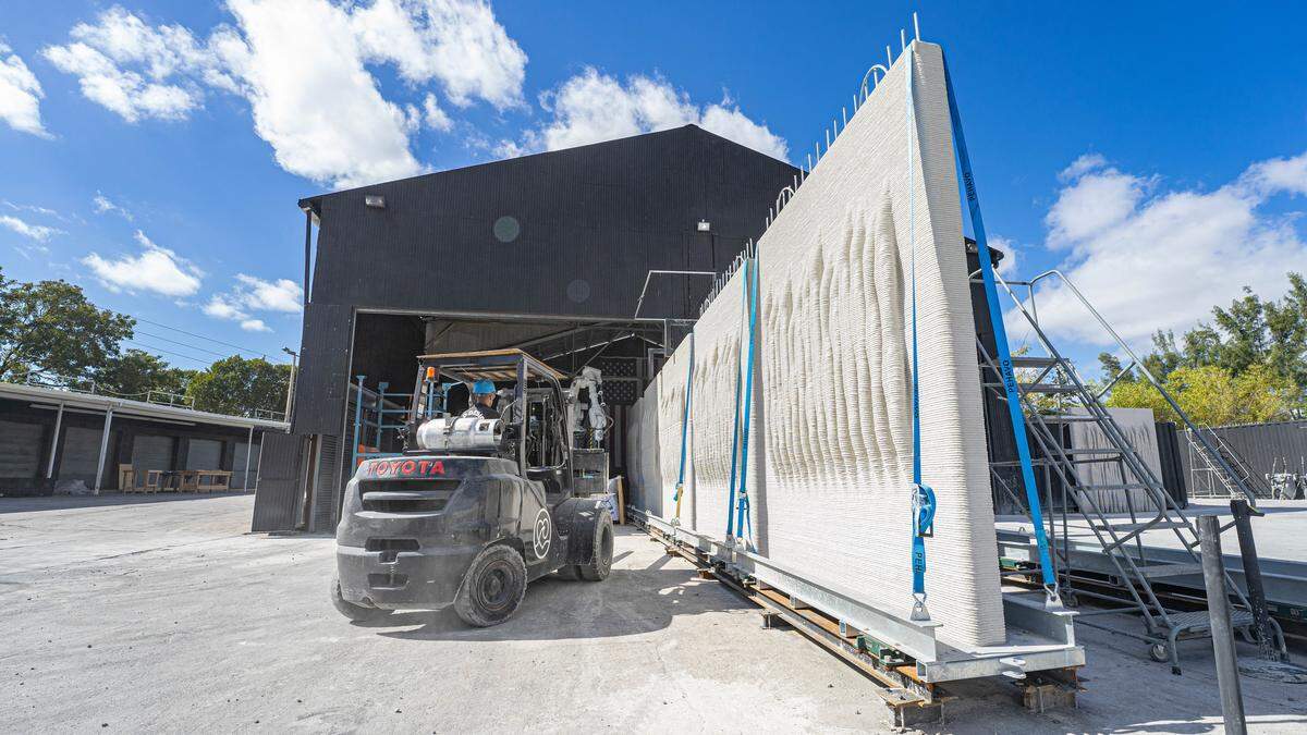 A Kind Design employee drives a forklift next to 3D-printed seawalls at the company headquarters in Miami, Fla. on Jan.10, 2025.