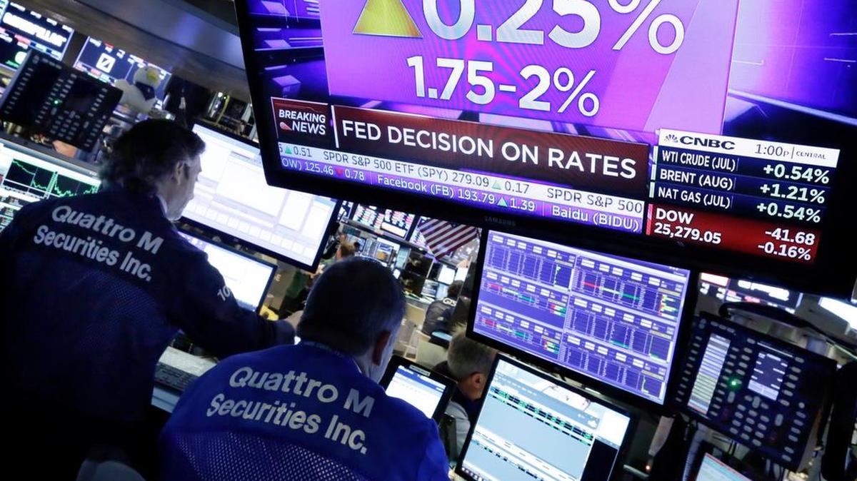A TV screen at the New York Stock Exchange shows the rate decision of the Federal Reserve on Wednesday. The Fed raised its benchmark interest rate for the second time this year on Wednesday and signaled that it may step up its pace of rate increases because of solid economic growth and rising inflation.