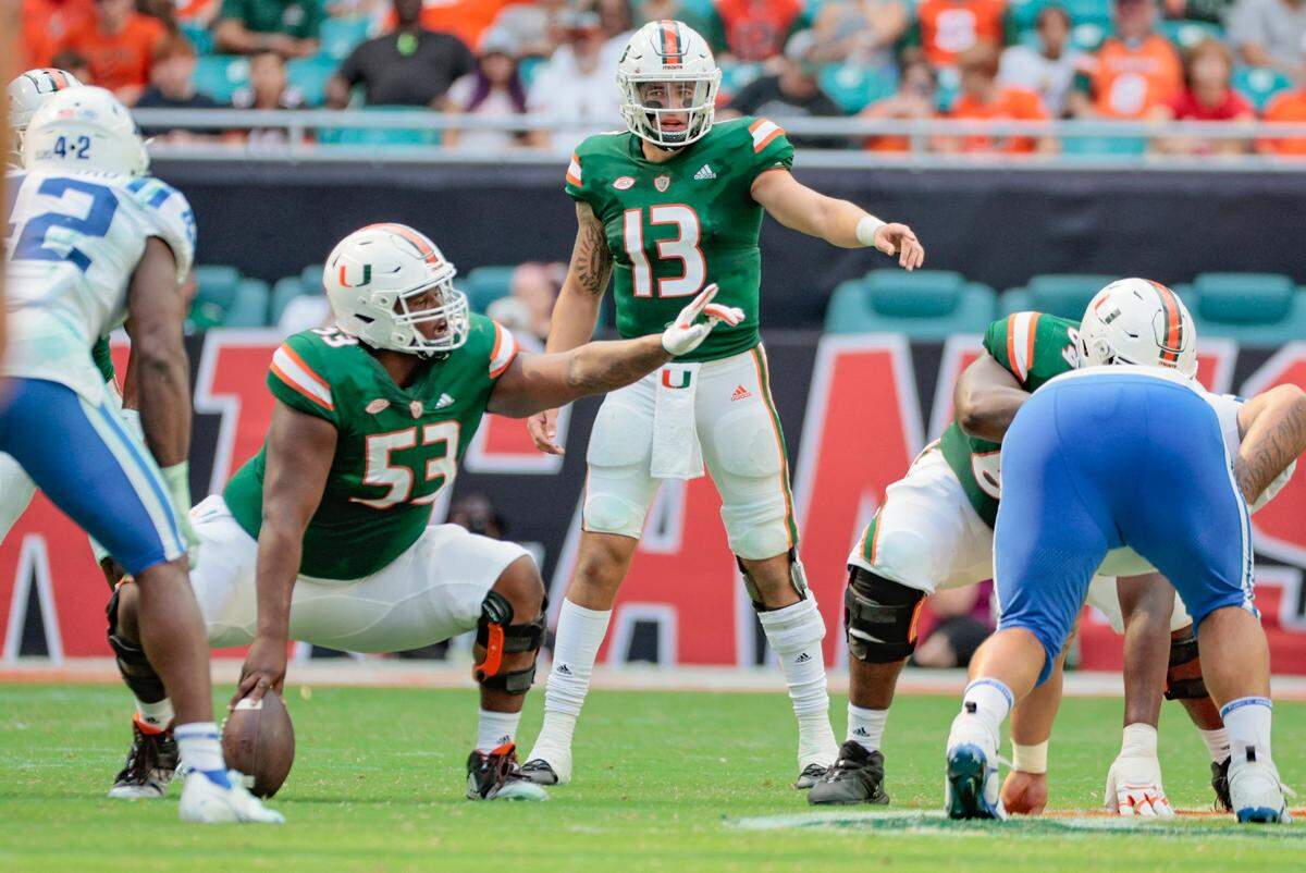 Miami Hurricanes quarterback Jake Garcia (13) and offensive lineman Jakai Clark (53) gesture during game against Duke Blue Devils in the second half at Hard Rock Stadium in Miami Gardens on Saturday, October 22, 2022.