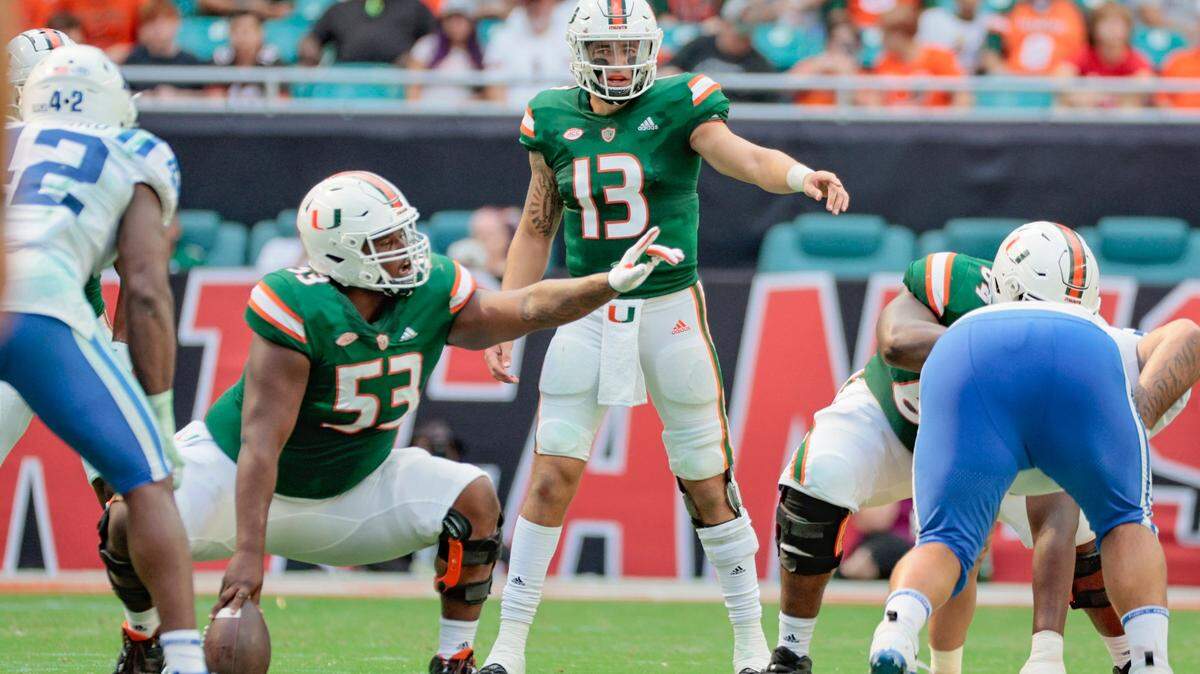 Miami Hurricanes quarterback Jake Garcia (13) and offensive lineman Jakai Clark (53) gesture during game against Duke Blue Devils in the second half at Hard Rock Stadium in Miami Gardens on Saturday, October 22, 2022.