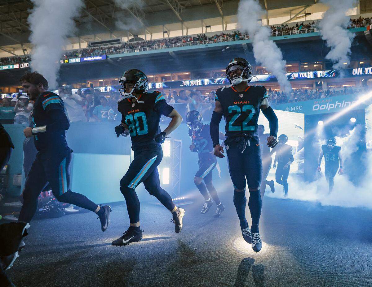 The Miami Dolphins rush the field for their NFL game against the New York Jets at Hard Rock Stadium in Miami Gardens, Florida, on Monday, September 29, 2025. 