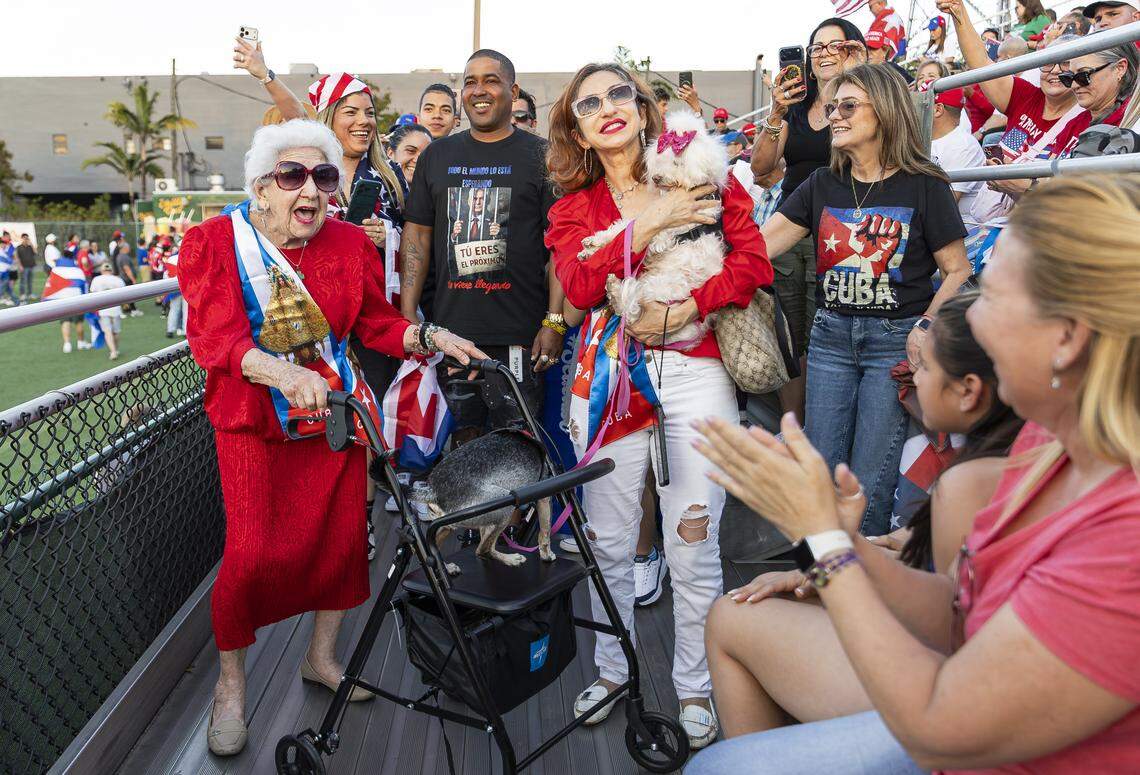Inalbis de la Torre, 91, far-left, her dog Luci, and her daughter, Yali de la Torre, along with her dog Lola, react as they attend the Free Cuba Rally at Milander Park on Tuesday, March 24, 2026, in Hialeah, Fla. The demonstration, which was organized in part by the City of Hialeah, aims to bring together voices of the Cuban exile community in support of Cuba's freedom.