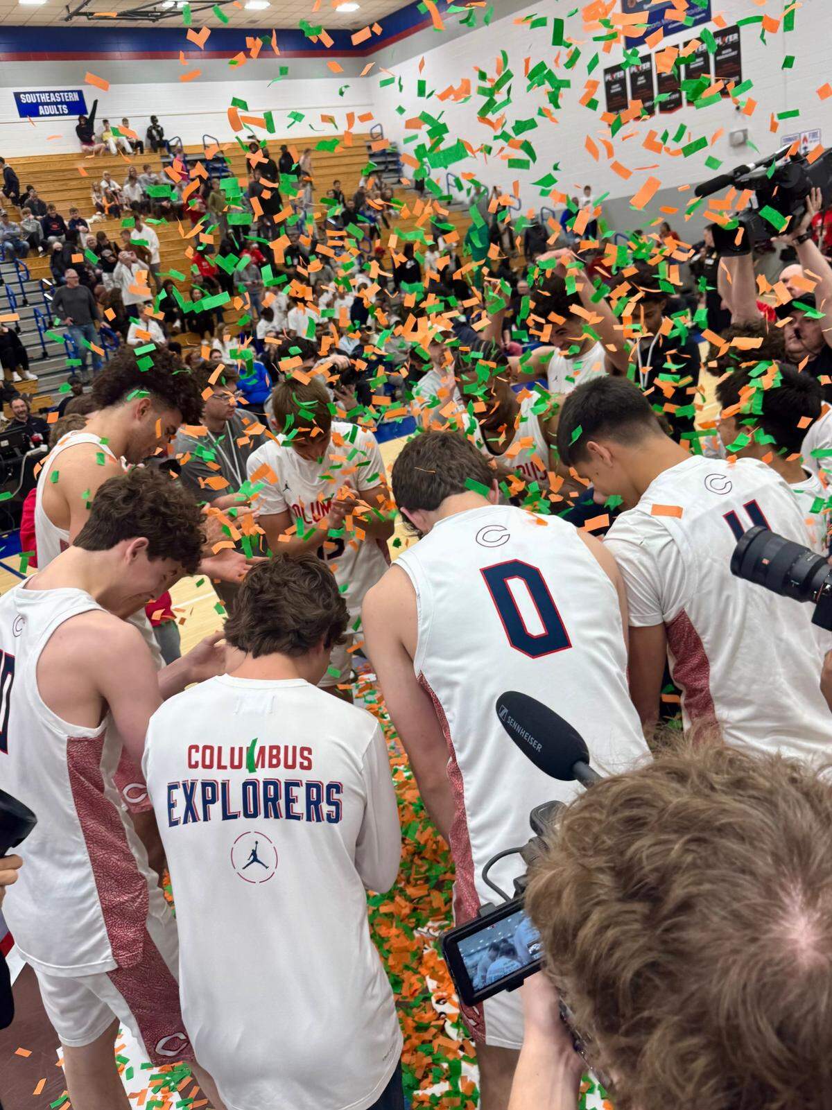 Confetti floats down onto the Columbus basketball players shortly after winning the Chipotle Nationals championship on Saturday in Fishers, Indiana.