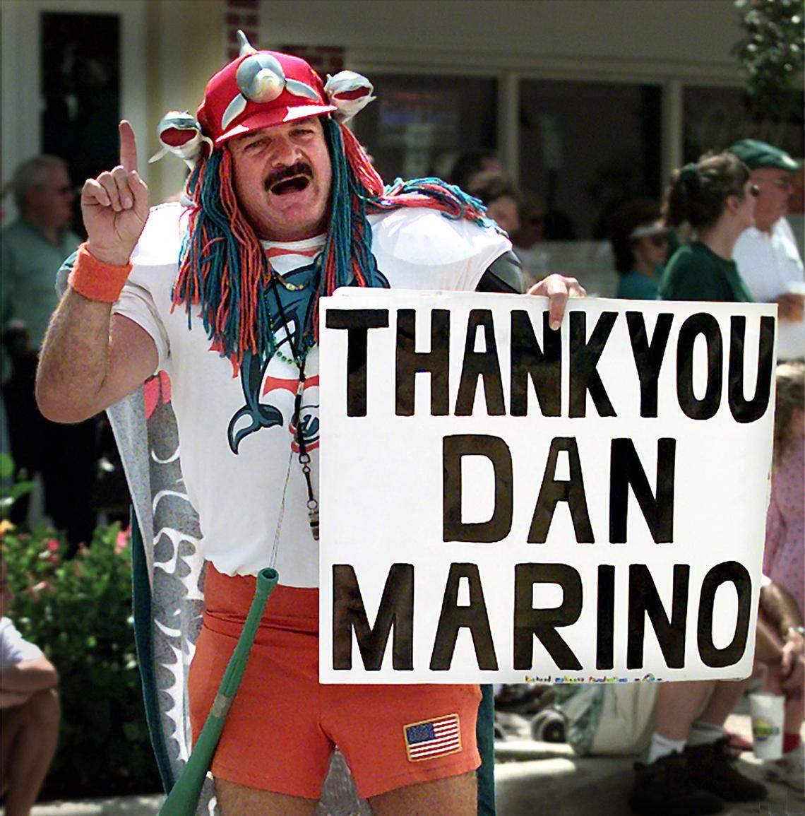BROWARD -- 3/12/00 -- MARSHA HALPER/Herald Staff “Dolfan Denny,” a longtime fan of the Miami Dolphins, expresses his sentiments about the team’s quarterback of 17 seasons, Dan Marino, whose impending retirement saddens many fans. “Dolfan Denny” displayed his sign Sunday while walking in the St. Patrick’s Day Millennium Parade in downtown Hollywood.