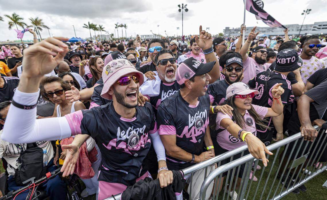 Vincenzo Suarez, left, and Joan Carlos Wizel, center, dance and cheer as they wait to enter Nu Stadium in Miami Freedom Park before an MLS match between Inter Miami CF and Austin FC on Saturday, April 4, 2026, in Miami, Fla.