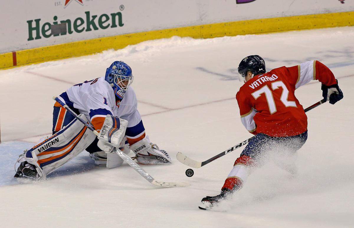 New York Islanders goalie Thomas Greiss (1) makes a save against Florida Panthers center Frank Vatrano (72) during the shootout of an NHL regular season hockey game at the BB&T Center on Thursday, April 4, 2019 in Sunrise.