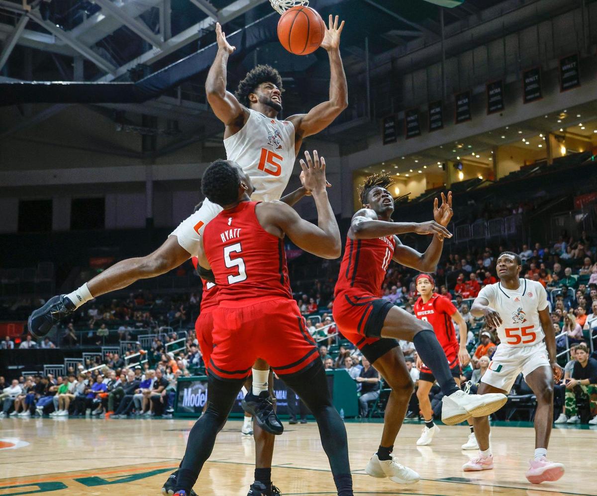 Miami Hurricanes forward Norchad Omier (15) jumps for a rebound as he battles Rutgers Scarlet Knights center Clifford Omoruyi (11) and Rutgers Scarlet Knights forward Aundre Hyatt (5) in the second half at the Watsco Center in Coral Gables on Wednesday, November 30, 2022.
