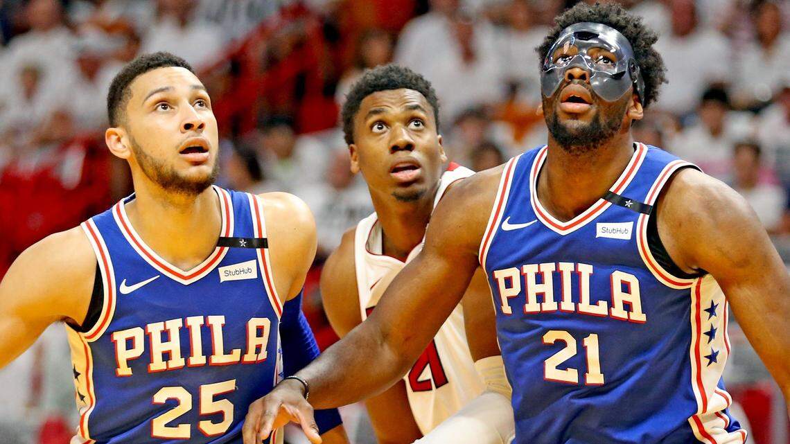 Miami Heat Hassan Whiteside (21) is flanked by Philadelphia 76ers Ben Simmons (25) and Joel Embiid (21) in the first quarter in Round 1, Game 4, of the NBA Playoffs at the AmericaneAirlines Arena in Miami, Florida, April 21, 2018.