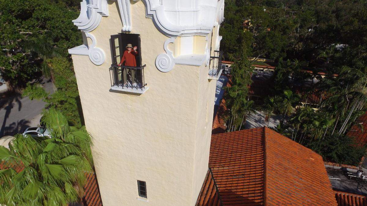 Rev. Laurinda Hafner waves from her church’s tower.