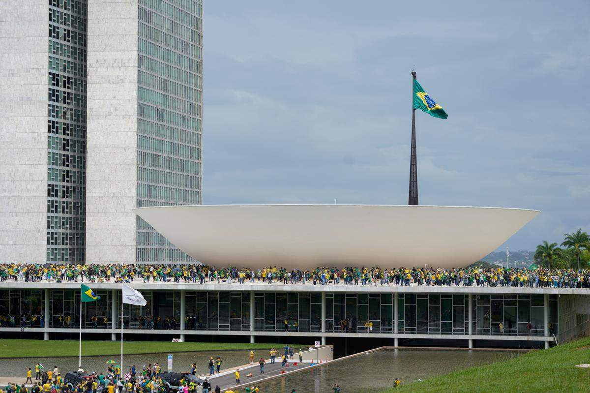 Protesters, supporters of Brazil’s former President Jair Bolsonaro, storm the the National Congress building in Brasilia, Brazil, Sunday, Jan. 8, 2023. (AP Photo/Eraldo Peres)