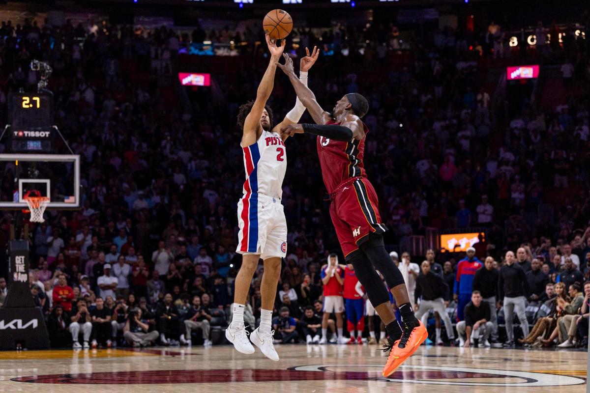 Detroit Pistons guard Cade Cunningham (2) shoots a game-winning three-pointer over Miami Heat center Bam Adebayo (13) to defeat the Heat 116-113 during the second half of an NBA game at Kaseya Center on Wednesday, March 19, 2025, in Miami, Florida.
