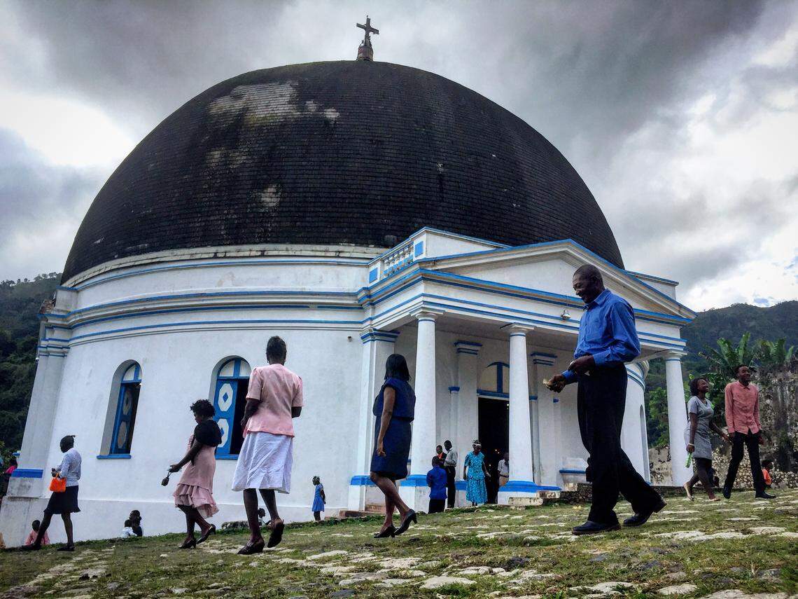 In happier times, residents of Milot leave Our Lady of the Immaculate Conception Church after Mass. Built after the Haitian Revolution, the historical landmark lost its domed room and interior to a fire on Monday, April 13, 2020.