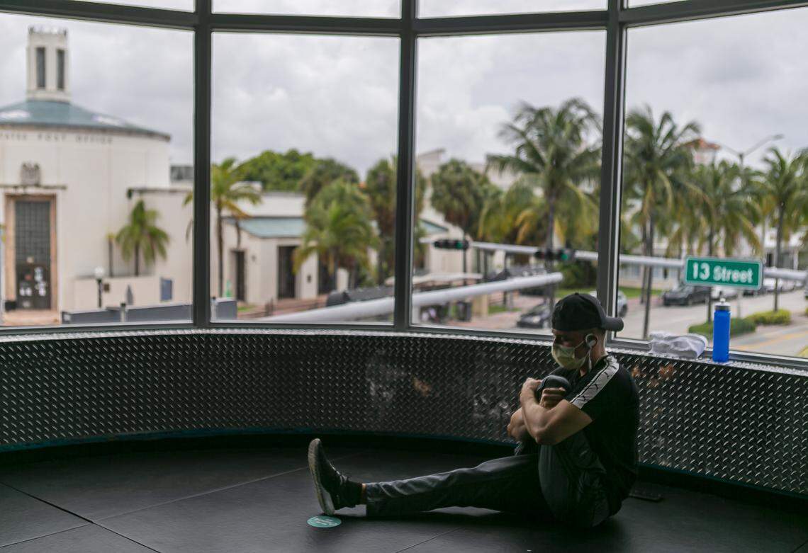 Lukasz Jablonski, 25, stretches before exercising at a Crunch Fitness in Miami Beach, Florida on Monday, June 8, 2020. Miami-Dade officials lifted a ban that prevented gyms from operating because of the coronavirus pandemic.