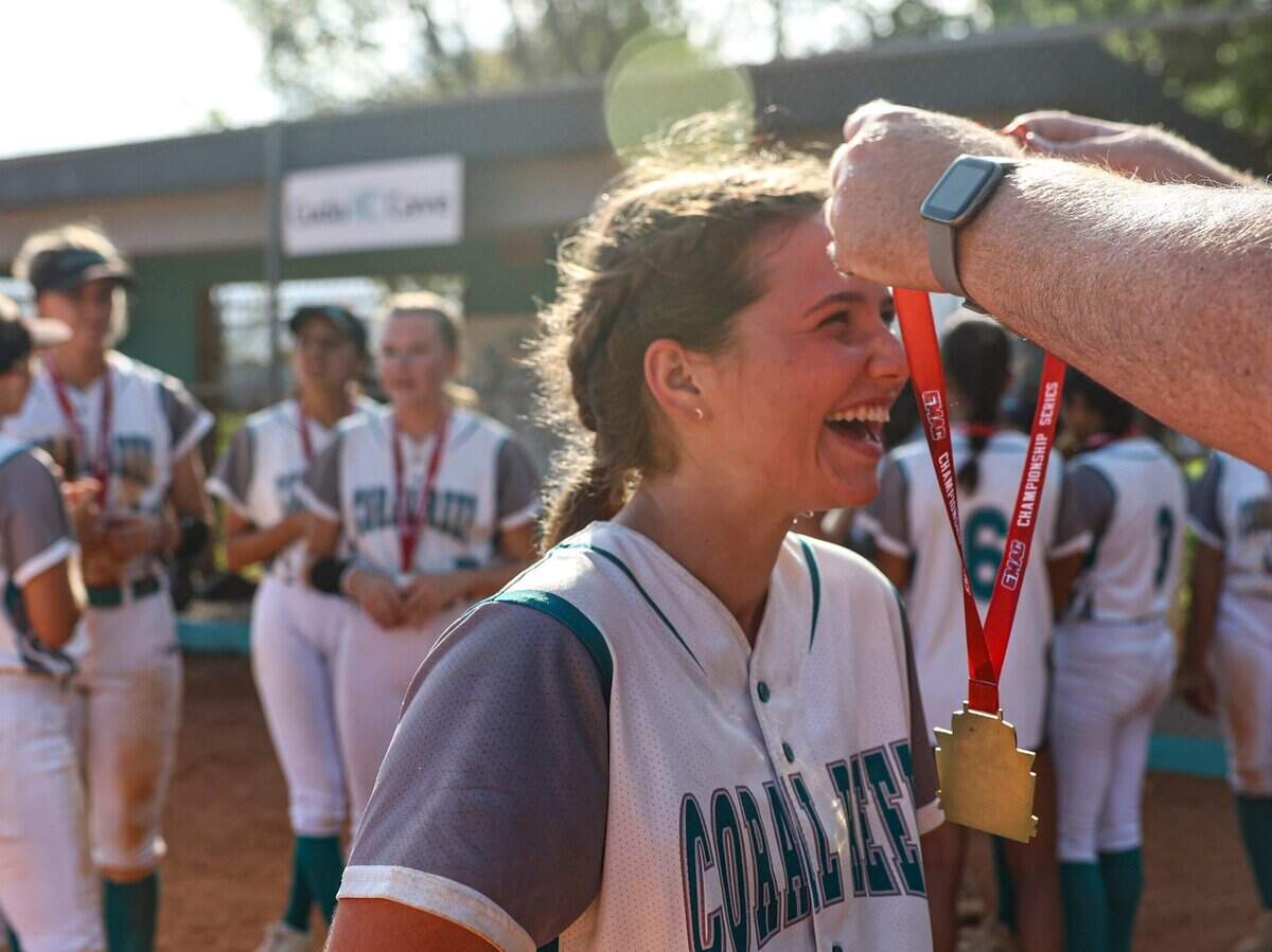 Coral Reef’s catcher Char Diedrick (10) gets a medal after the team won the Greater Miami Athletic Conference softball final against Palmetto on Thursday, April 20, 2023, at Coral Reef High School in Richmond Heights, Florida.