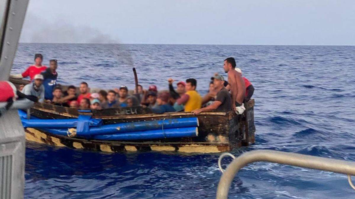 Several people sit packed on a Cuban migrant boat off Marquesa Key Wednesday, June 8, 2022.