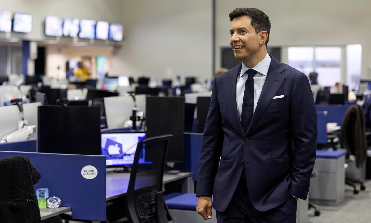 Tom Llamas walks through the NBC 6 South Florida newsroom, where he previously worked.