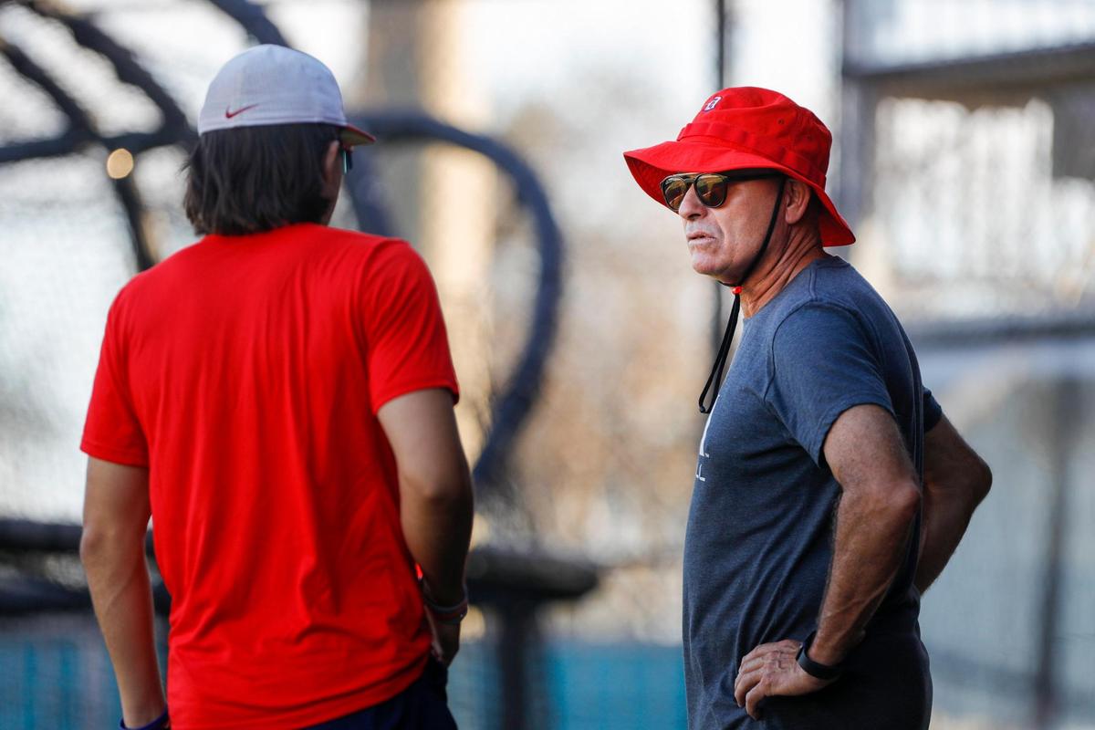 Doral Academy head coach Ralph Suarez talk to one of his players during baseball practice at Doral Academy High School in Doral, Florida on Tuesday, February 7, 2023.