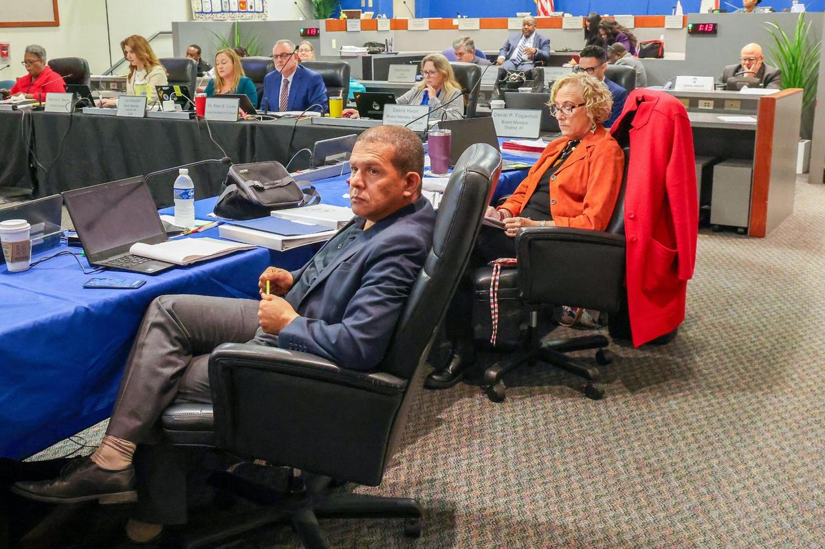 Dr. Jeff Holness (District 5), left, Nora Rupert (District 7), and other members of the school board listen to opening remarks at the workshop to discuss school closures.