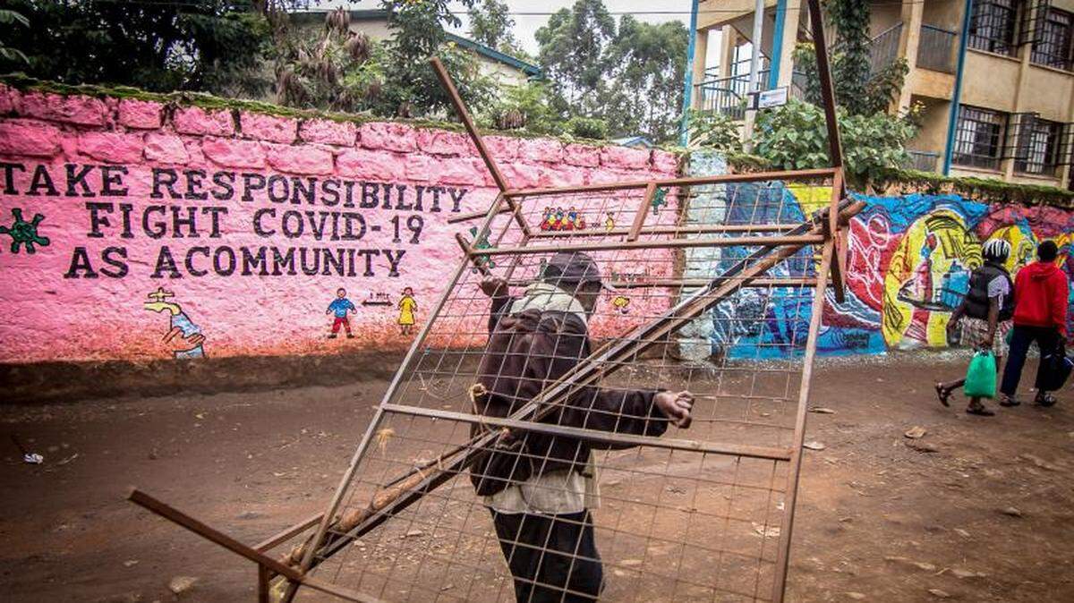 A message on a wall reminds people in a Nairobi, Kenya, neighborhood that everyone has a role to play in stopping the spread of COVID-19.