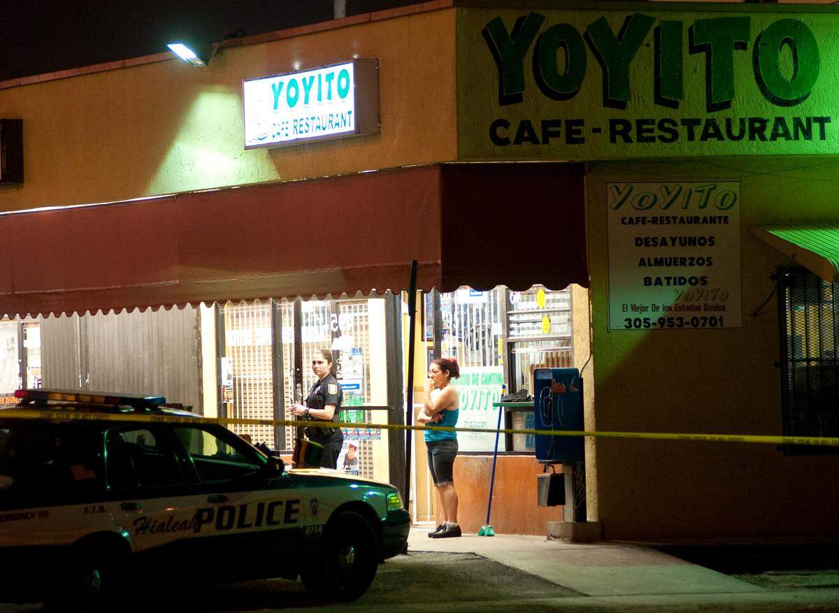 Police interview wittness after man open fire injuring seven and killing four at shortly before closing at Yoyito Restuarant in Hialeah, Florida, Sunday night June 6th, 2010.