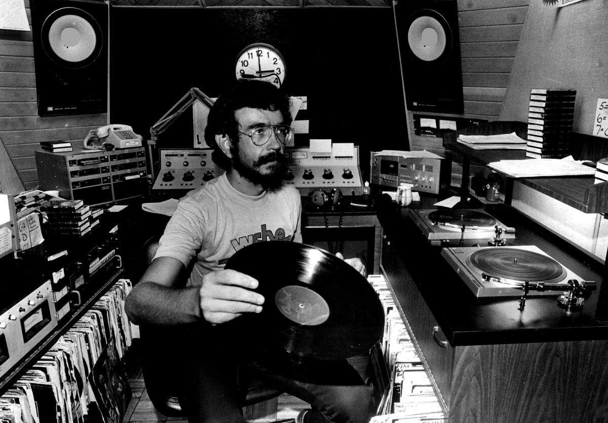 WSHE Disc Jockey Dave Michaels Puts away one of the records at the studio.