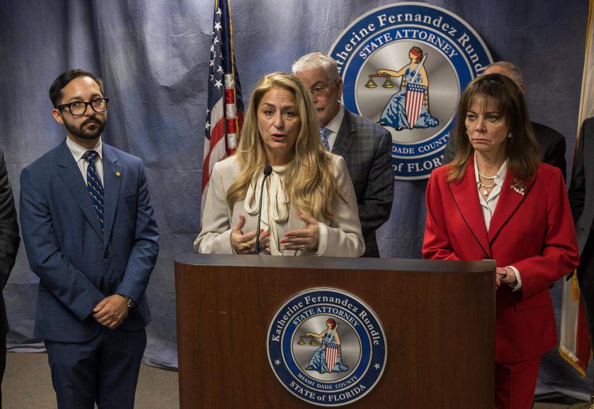 Chicky Ardisson, VP of the Hammock Association (on podium) was among a group of several dignitaries and elected officials including State Representative Juan Carlos Porras who joined Miami-Dade State Attorney Katherine Fernandez Rundle to talk about $2 million HOA fraud after the president and her husband admitted to their roles in the fraud, on Thursday, April 30, 2026.
