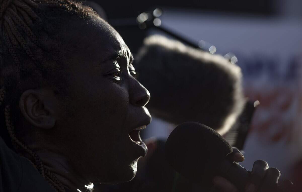 Santcha Etienne speaks during a rally at the Little Haiti Cultural Center on Thursday, July 9, 2026, in Miami, Fla. The event called for protections for Temporary Protected Status (TPS) holders and other immigrants after the Trump administration stripped many of them of legal protections against deportation.