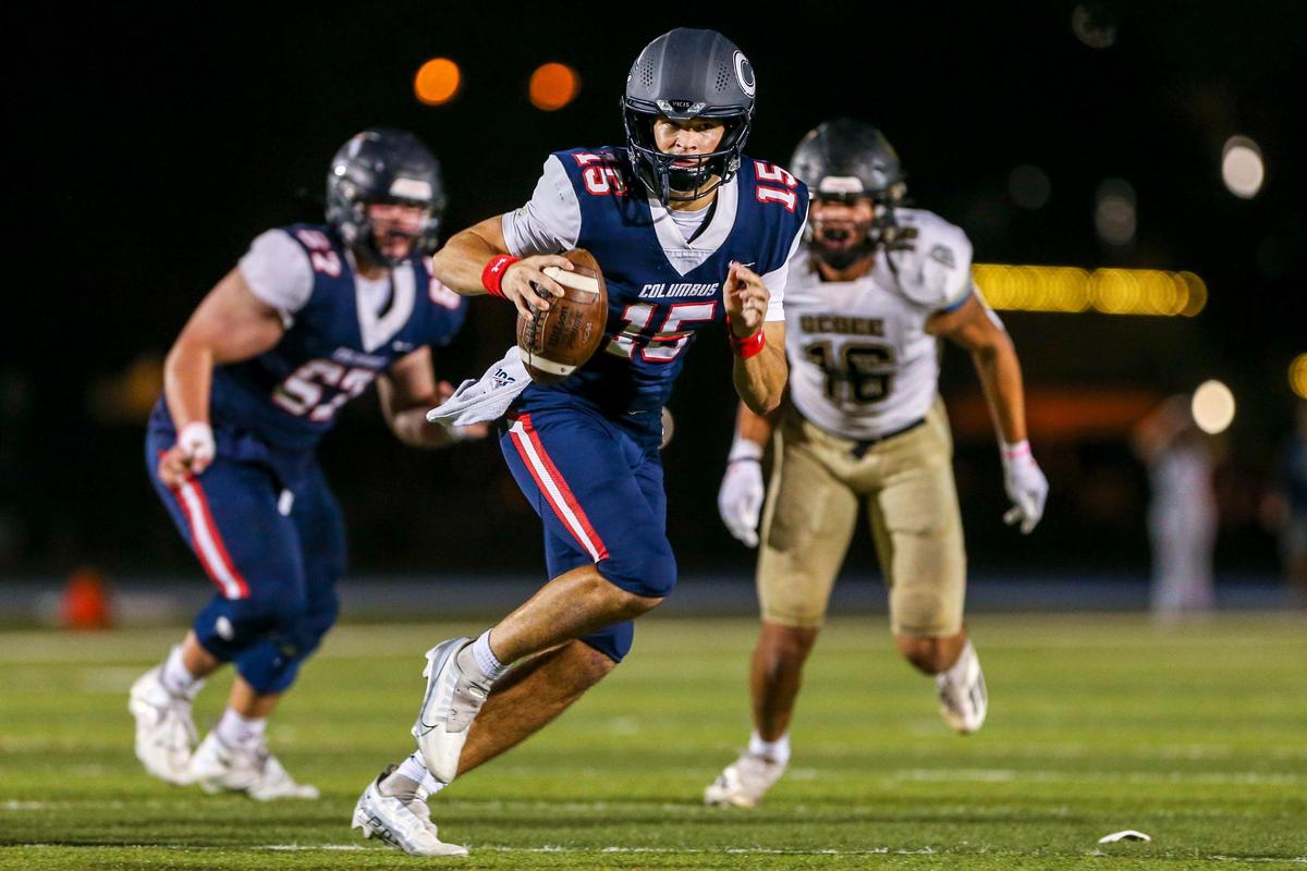 Columbus quarterback Alberto Mendoza (15) runs with the football during the second quarter of a high school football semifinal game against Ocoee at Tropical Park in Miami, Florida, Friday, December 2, 2022.