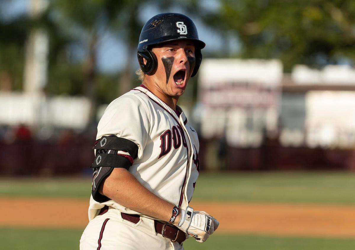 Marjory Stoneman Douglas’ Matthew Ossenfort (17) reacts after hitting a home run against Christopher Columbus in the second inning of their Region 4-7A baseball game final at Anthony Rizzo Field on Tuesday, May 16, 2023, in Parkland, Fla.