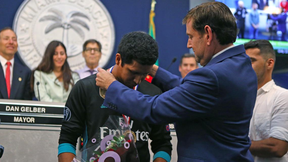 Helmut Muller Estrada is awarded with the City of Miami Beach Medallion by Commissioner Michael Góngora at the Miami Beach commission chambers on Wednesday, April 25, 2018.