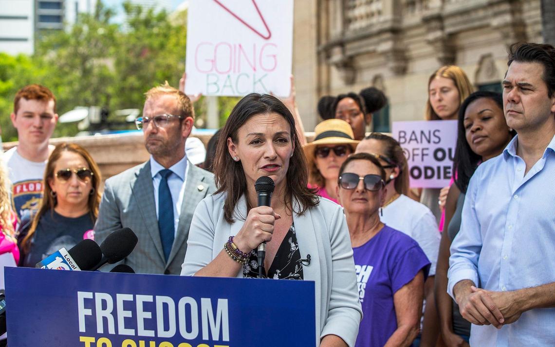 Local elected officials including City of Miami Commissioner Ken Russell, far right, and Florida Representative Michael Grieco, center, join Democratic candidate for governor and Florida Commissioner of Agriculture Nikki Fried as she speaks during a press conference about the leaked Supreme Court draft opinion on abortion rights. Tuesday May 3, 2022.