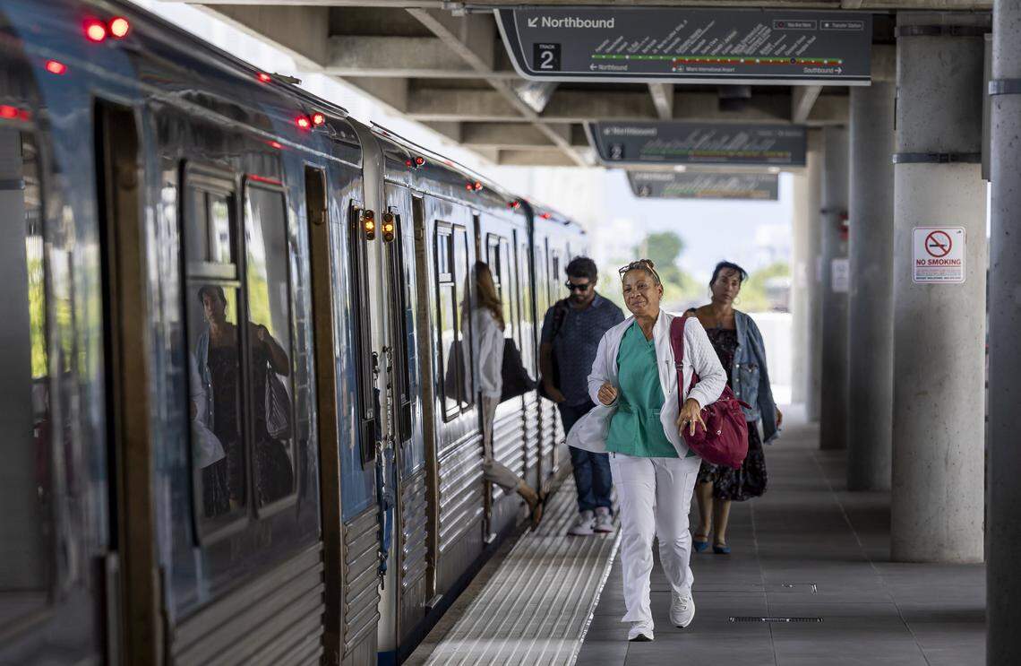 People board and exit a Metrorail train at the Douglas Road station on Thursday, Aug. 7, 2025, in Miami. 