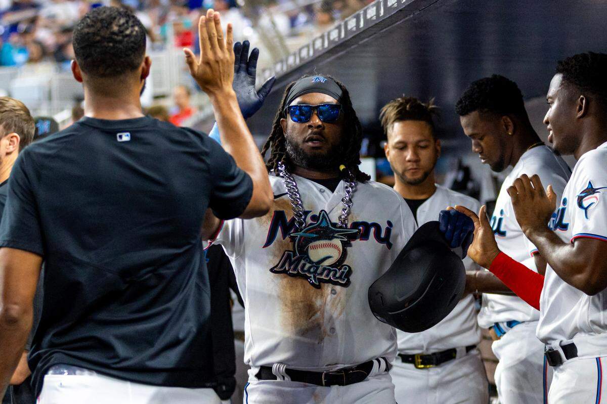 Miami Marlins base runner Josh Bell (9) reacts with teammates to homering during the sixth inning of an MLB game against the Philadelphia Phillies at loanDepot park in the Little Havana neighborhood of Miami, Florida, on Wednesday, August 2, 2023.