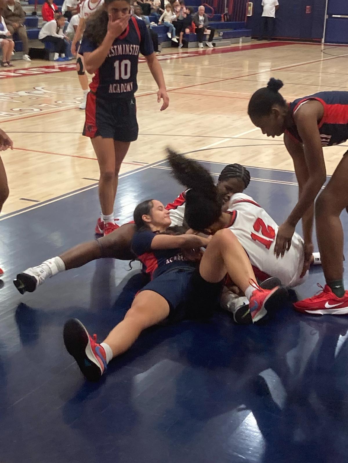 Miami Country Day’s Rachael Luis fights for the ball with a Westminster Academy player during Friday’s Region 4-2A girls’ basketball final at Miami Country Day School.