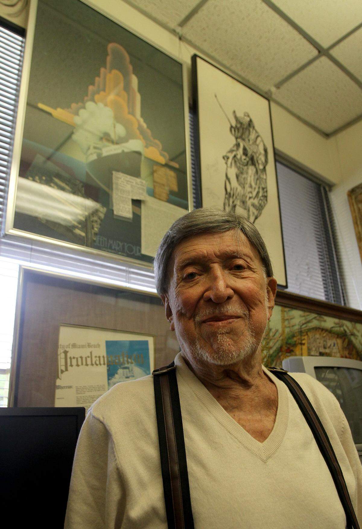 Ben Grenald poses in his office in Miami Shores in 2013 in front of a painting of the Queen Mary ship.